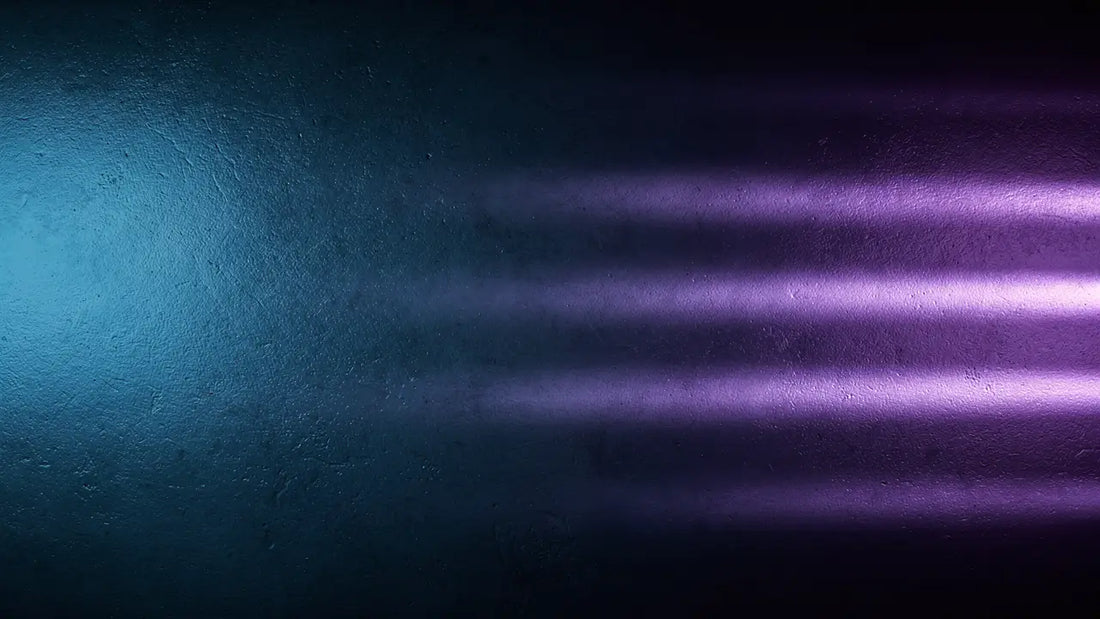 Cool blue and violet light beams across a dark textured wall